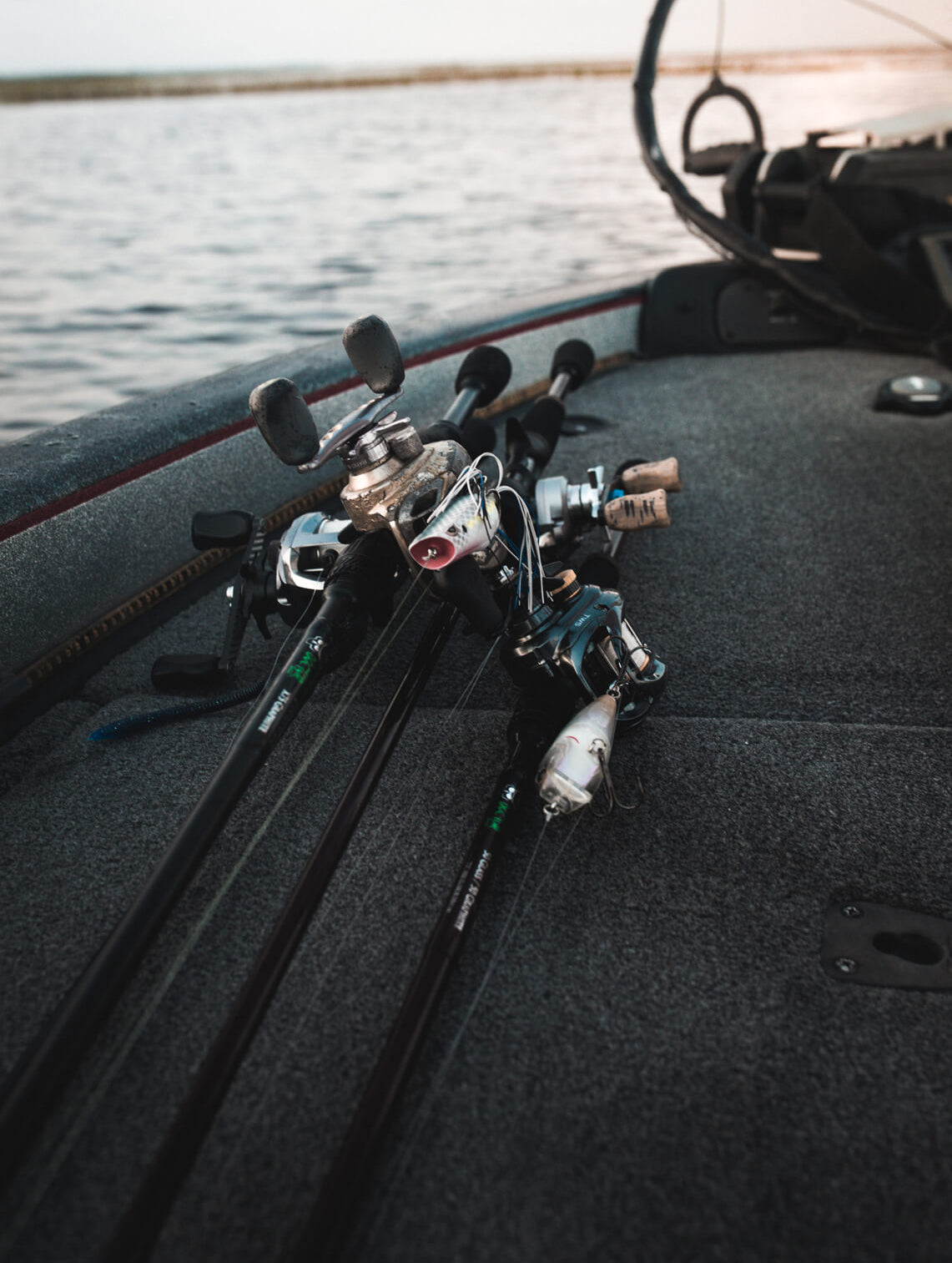 Four fishing poles are lying on a boat.