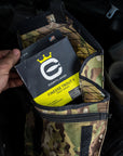 Someone pulling a Finesse Trout II box out of a camo bag