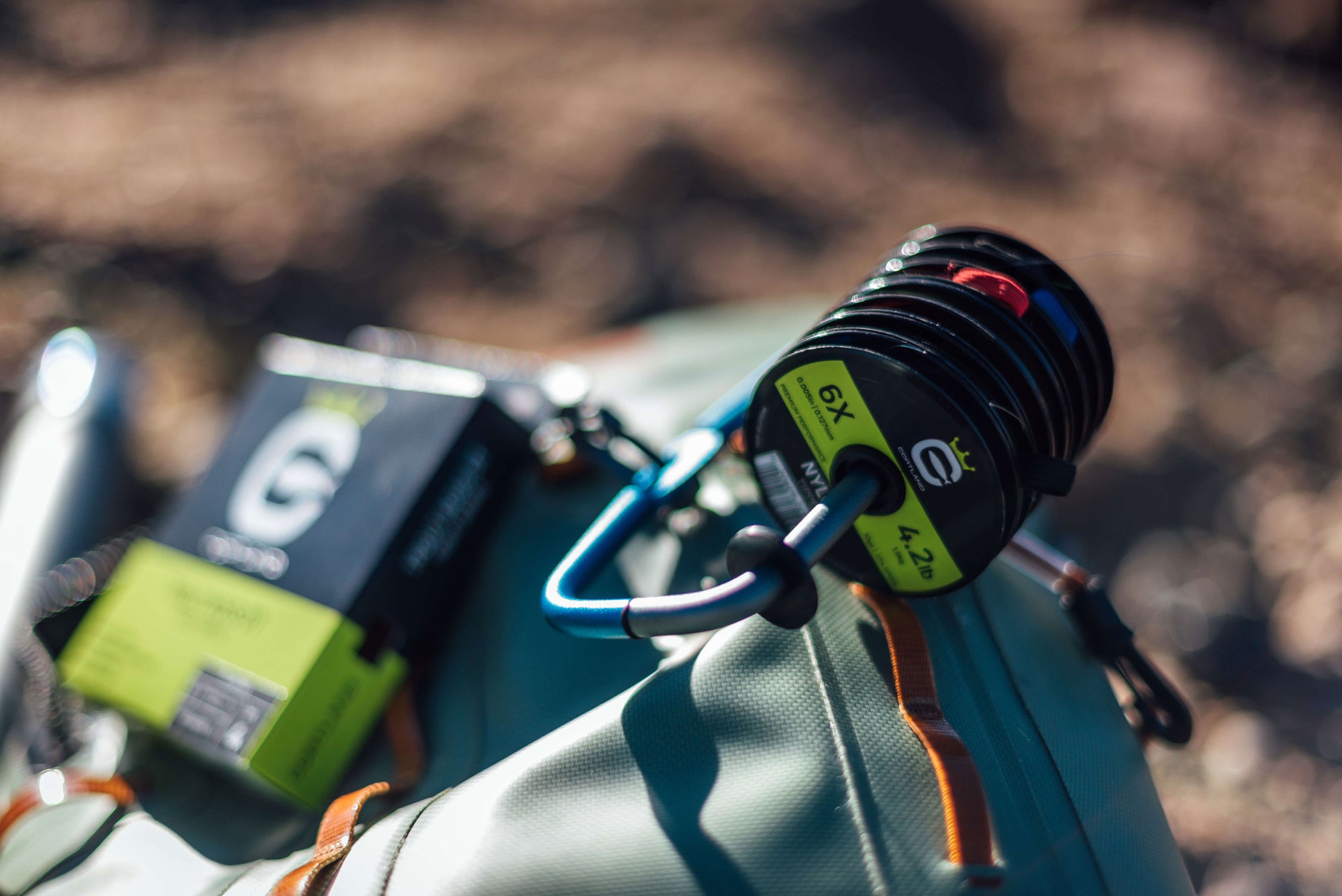 A variety of tippet spools attached to a bag