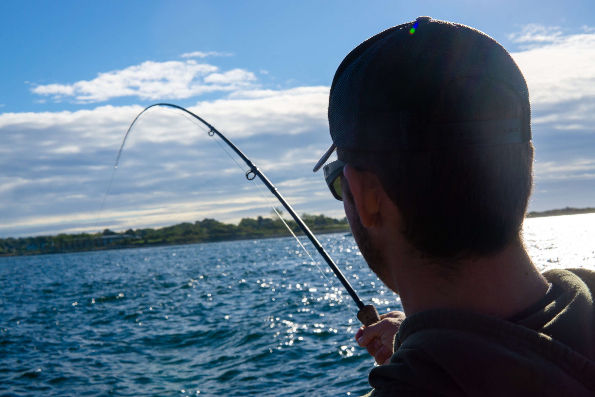 An angler is holding onto his fly rod