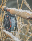 Closeup shot of the end of a fly rod lightly covered in snow.