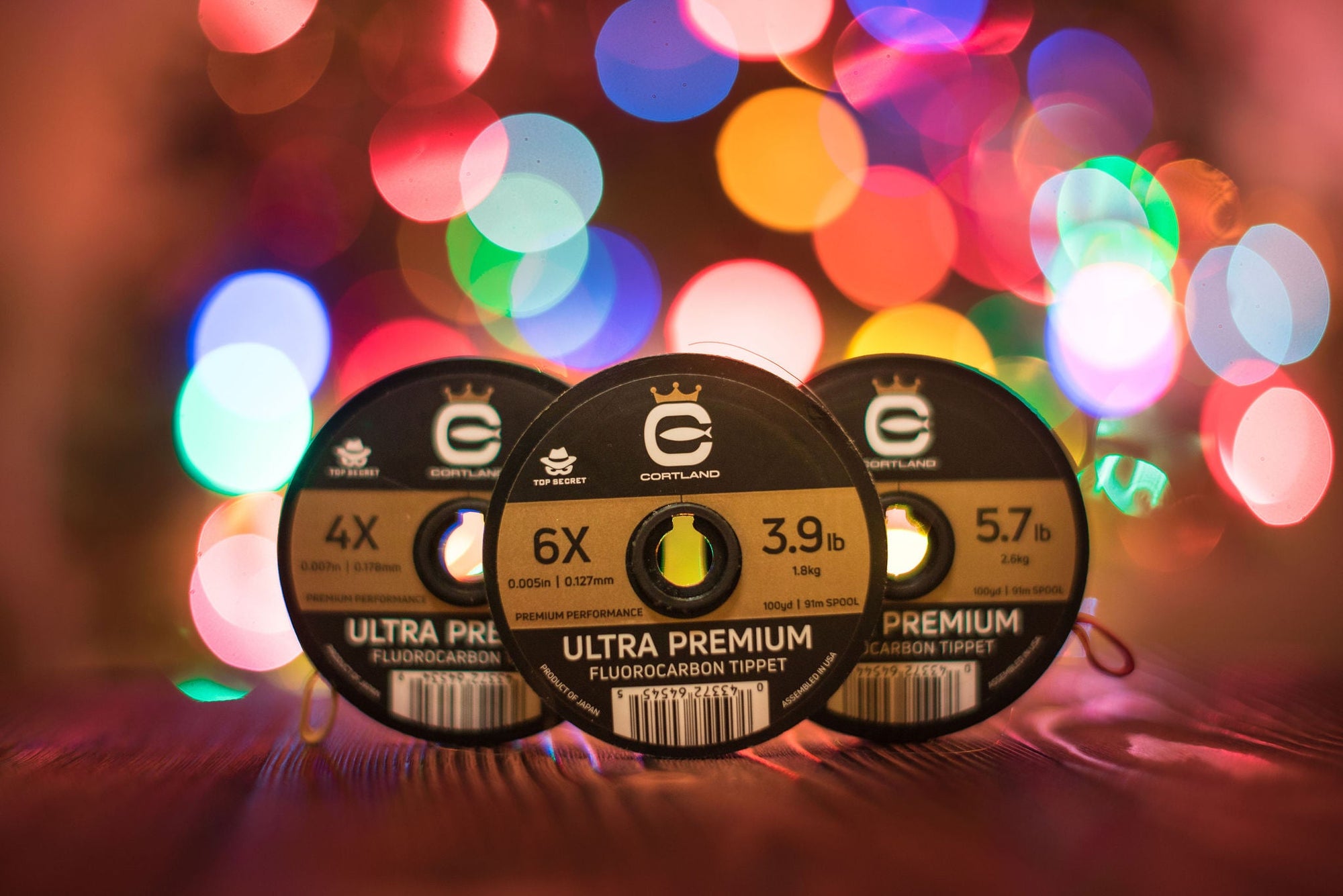 Three Ultra Premium Fluorocarbon Tippets with Christmas lights in the background 