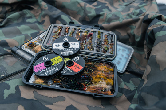 Closeup shot of a tackle box with various fly fishing flies and Indicator Mono Leader Material 