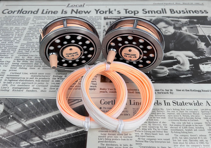 Peaches and Cream Fly Lines. Two lines are in front, and two in the back are on reels. Beneath the coils is a newspaper article 