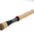 Fishing rod with cork handle and black reel on a white background