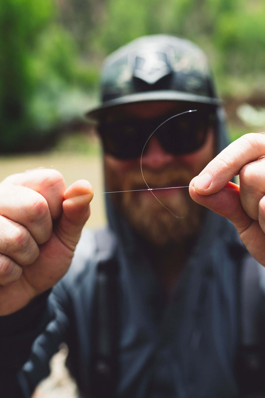 Angler tying a knot in his fly fishing tippet