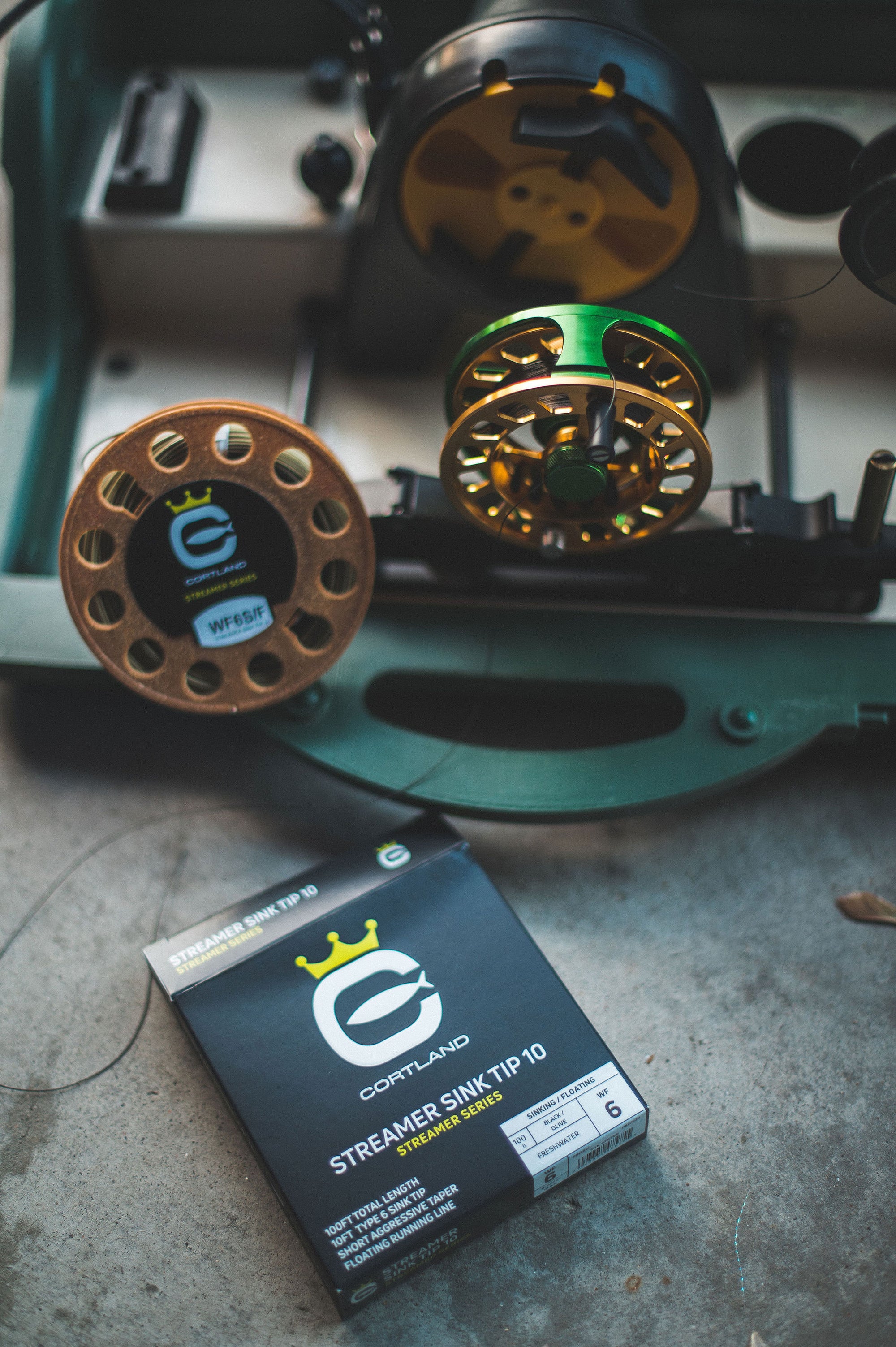 Streamer Sink Tip 10 Box at the bottom of the image with a few fly reels being prepared to be lined. 