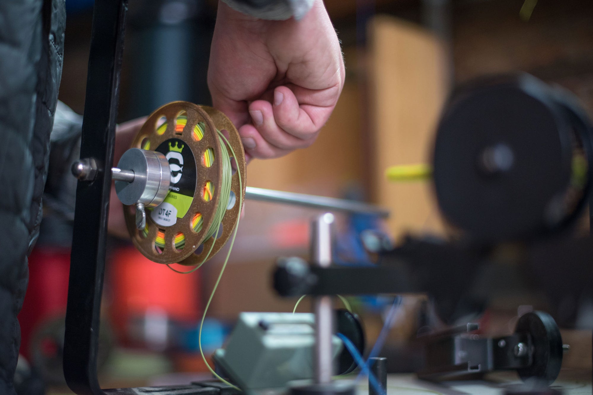 Closeup shot of hand setting up the Trout Boss DT on a fly line reel.